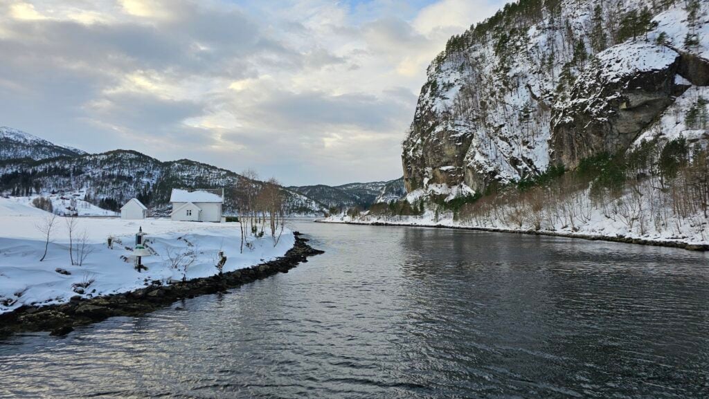 Snow-covered fjord landscape near Mostraumen outside Bergen with mountains and calm water