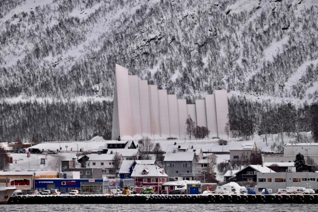 Close-up view of Tromsø’s Arctic Cathedral seen from Rødne boat during Arctic fjord cruise in Northern Norway.