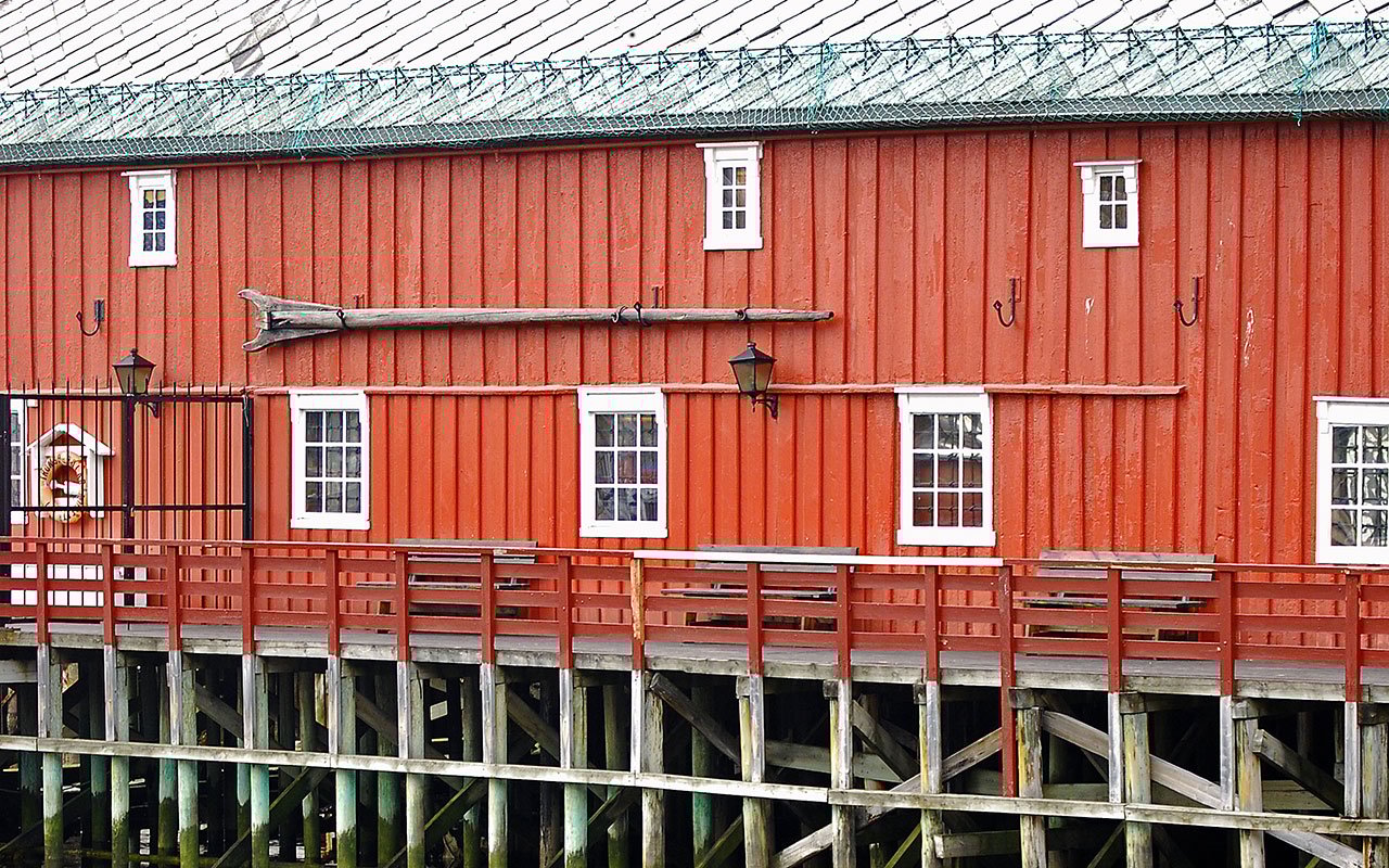 Historic red waterfront boathouse near the Polar Museum in Tromsø.