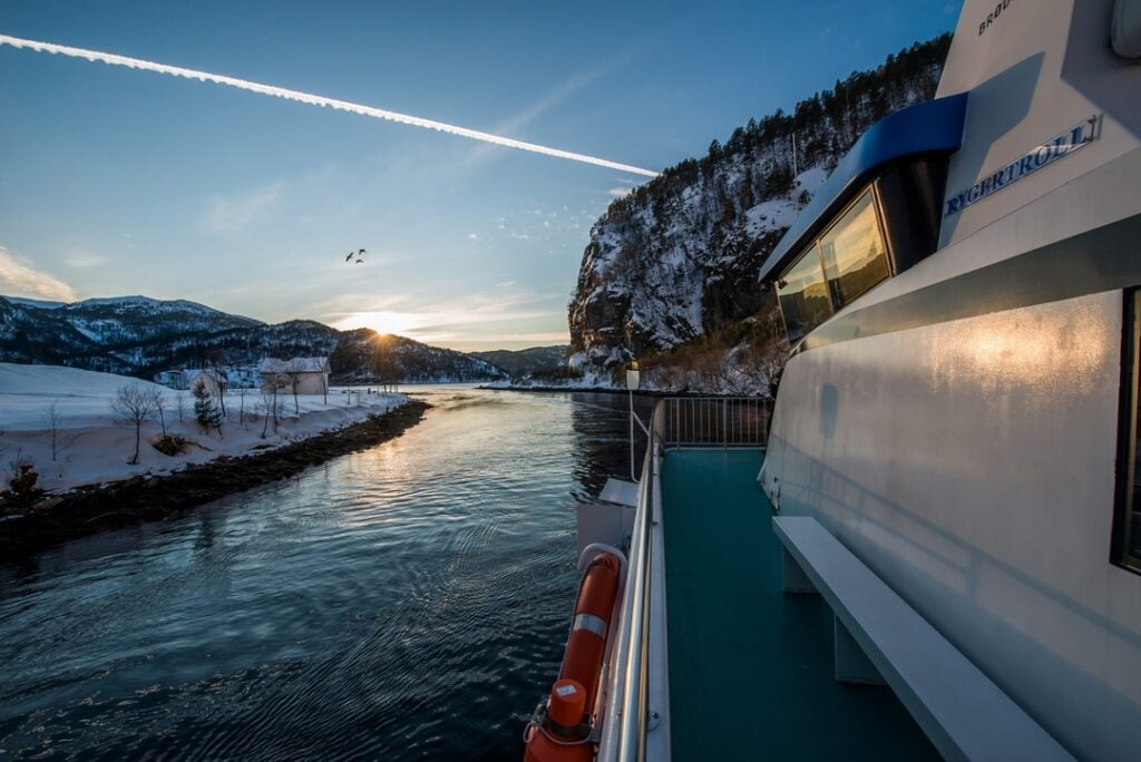 Winter fjord cruise from Bergen to Mostraumen with snow-covered mountains and narrow fjords