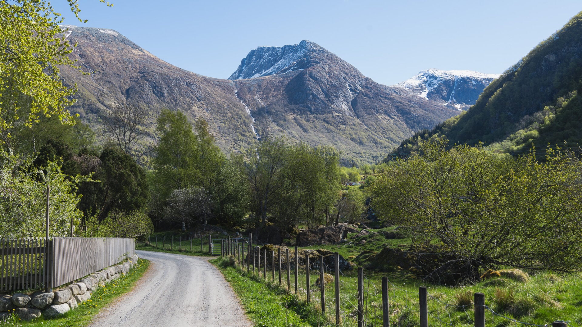 Scenic mountain road leading through the lush valley of Rosendal during a guided waterfall hike and day trip from Bergen in Hardangerfjord.