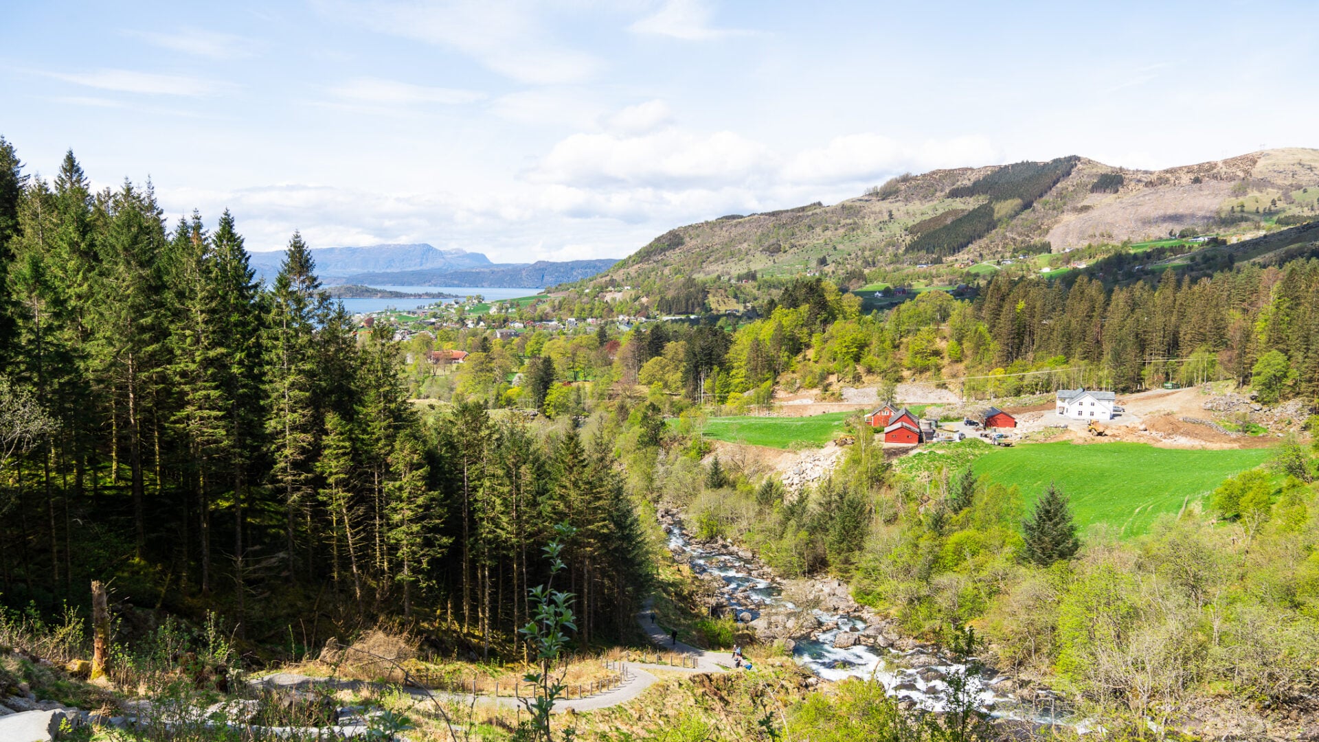 Scenic mountain road leading through the lush valley of Rosendal during a guided waterfall hike and day trip from Bergen in Hardangerfjord.